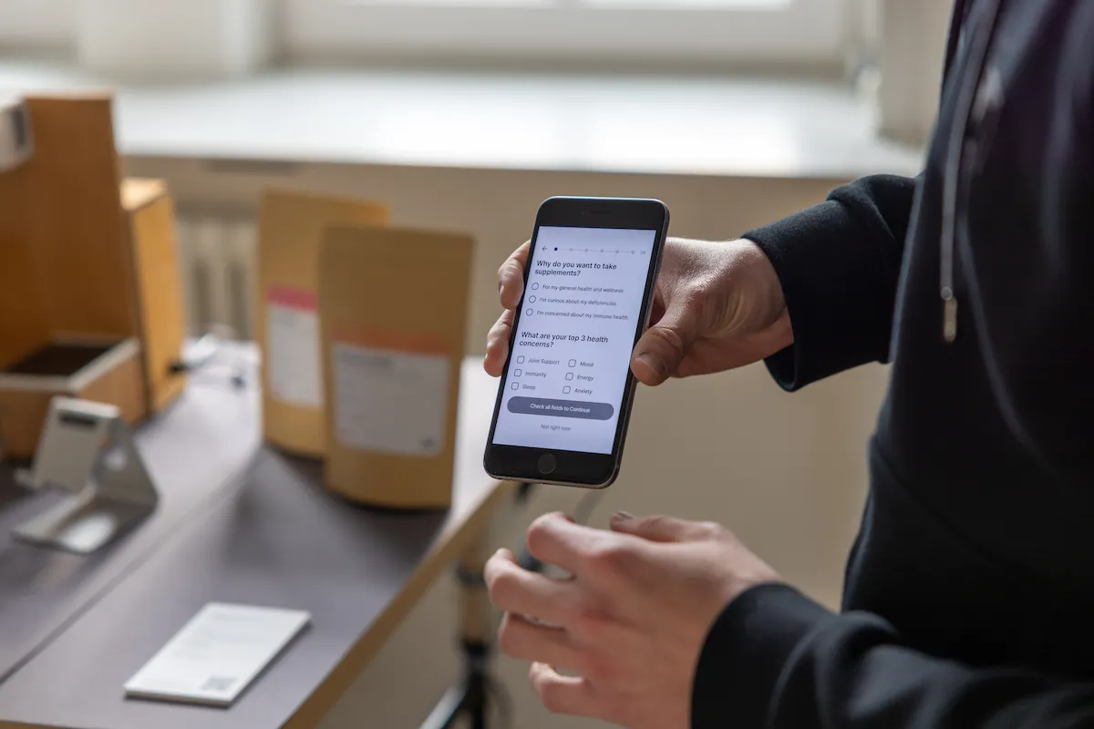 A person holding a phone with the Boost app open on the onboarding screen